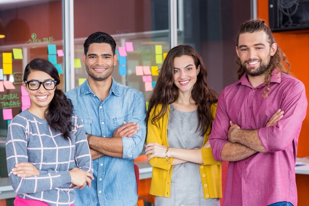 Portrait of smiling graphic designers standing with arms crossed