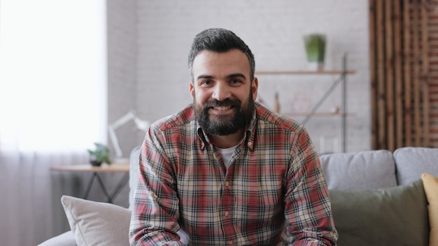 Portrait of smiling handsome bearded man. Beautiful human face.