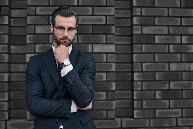 Portrait of a smiling handsome businessman with arms folded over