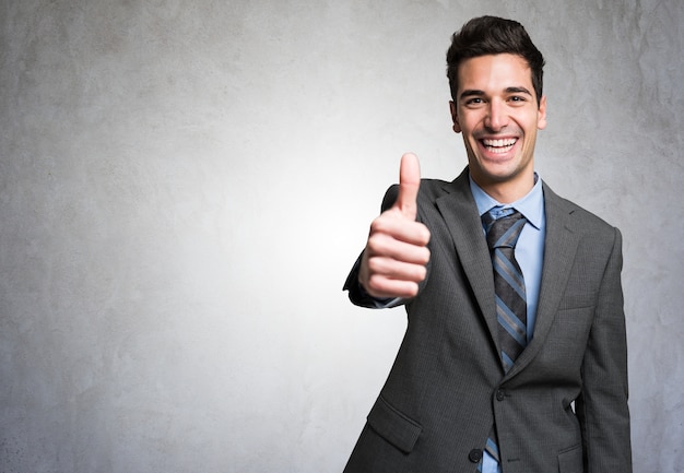 Portrait of a smiling happy man giving thumbs up