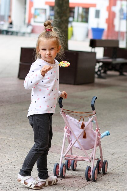 Portrait of smiling little girl with candy