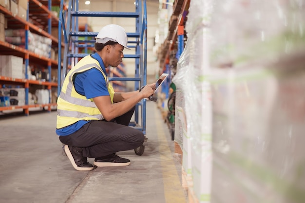 Portrait of smiling male warehouse worker using digital tablet in a warehouse