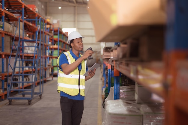 Portrait of smiling male warehouse worker using digital tablet in a warehouse