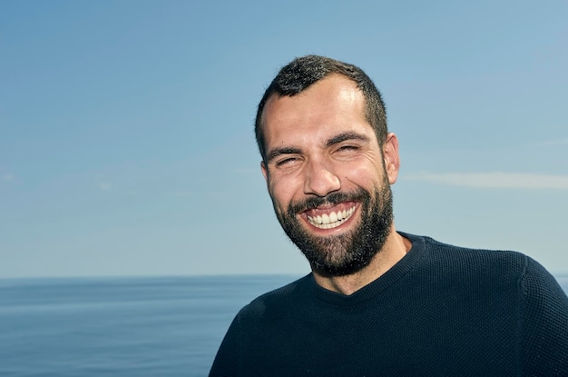 portrait of smiling man by sea
