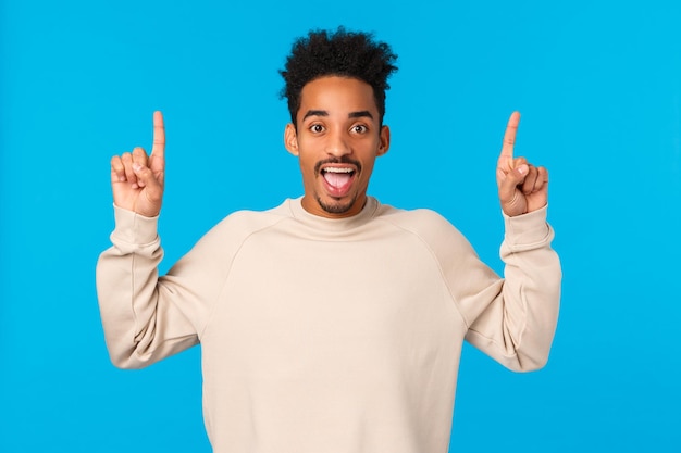 Portrait of smiling man standing against blue background