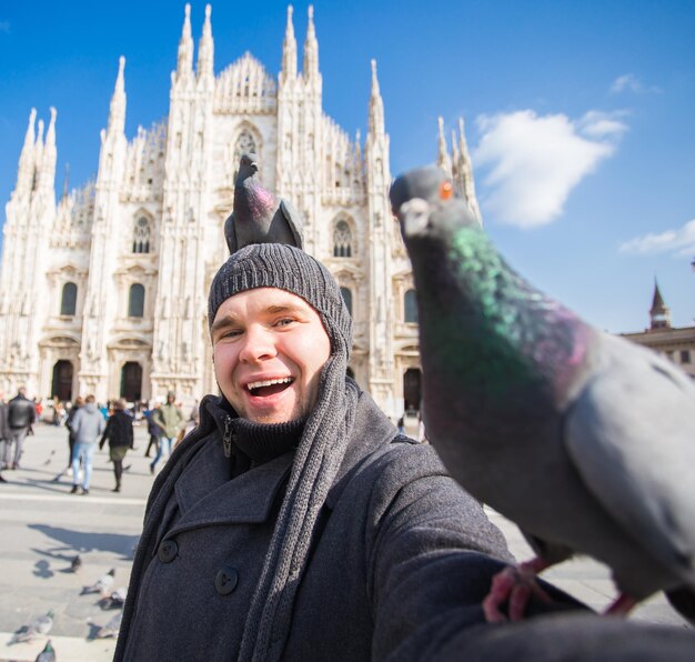 Portrait of smiling man standing against building