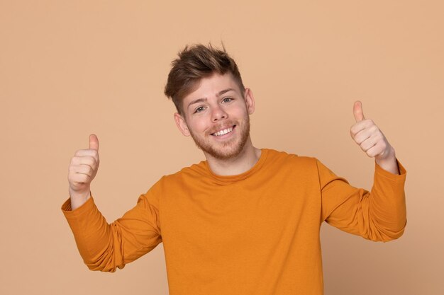 Portrait of smiling man standing against gray background