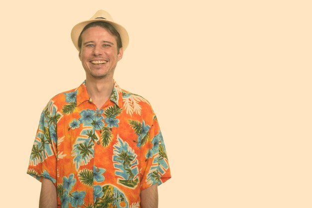 Portrait of smiling man standing against orange background