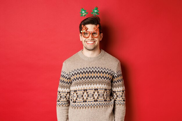 Photo portrait of smiling man standing against red background