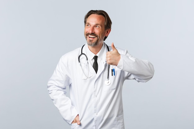 Portrait of smiling man standing against white background