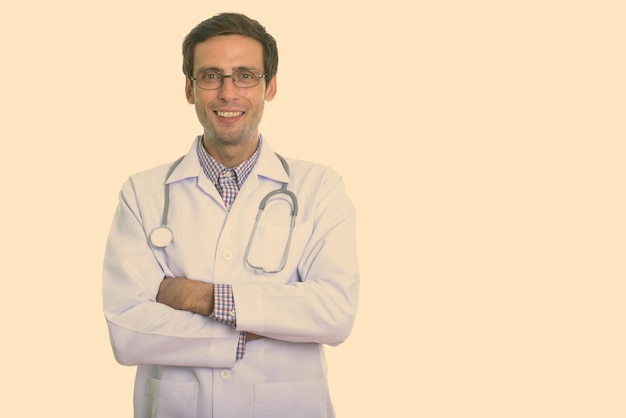 Portrait of smiling man standing against white background