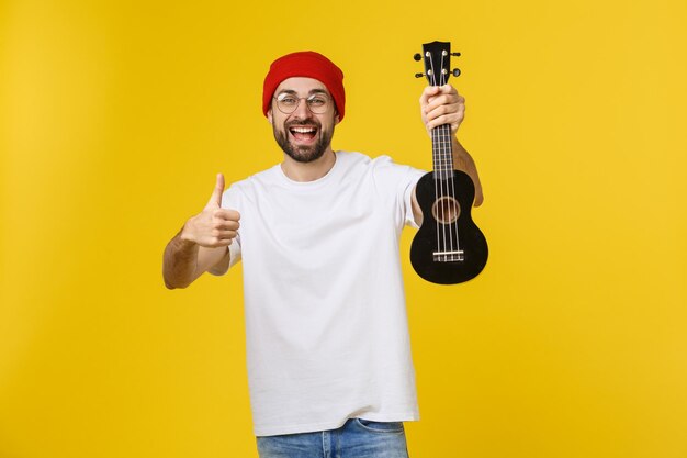 Portrait of smiling man standing against yellow background