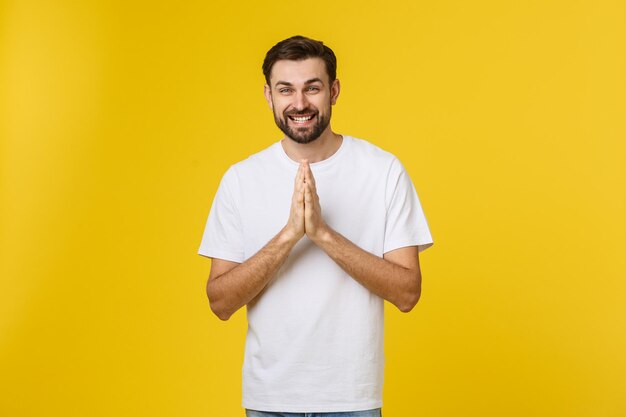 Portrait of smiling man standing against yellow background