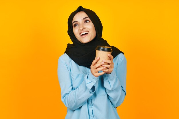 Portrait of smiling man standing against yellow background