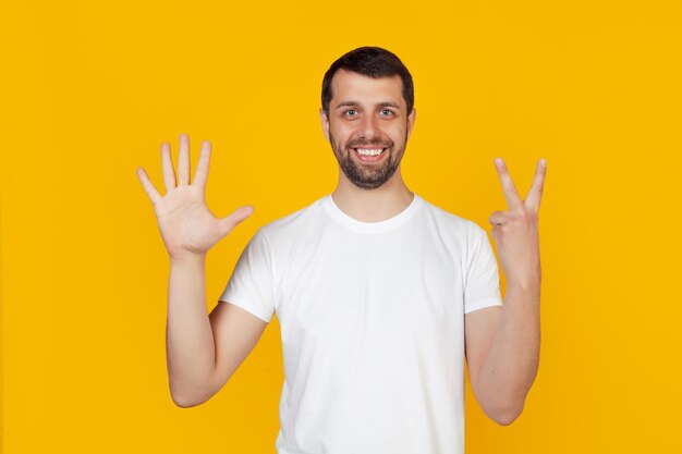 Portrait of smiling man standing against yellow background