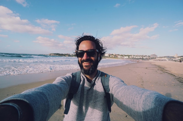portrait of smiling man standing on beach