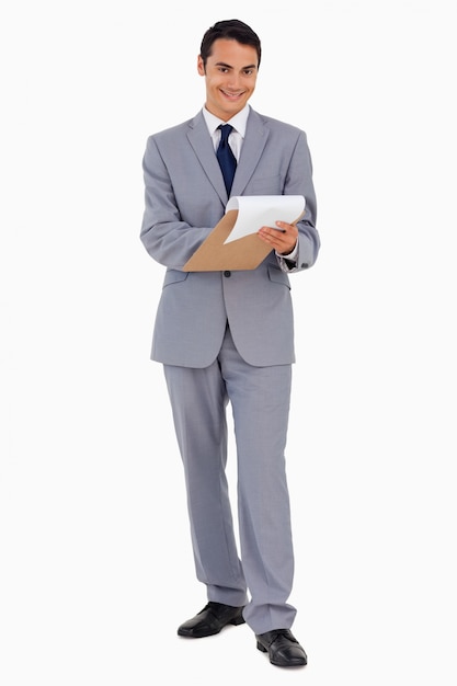 Portrait of a smiling man in suit watching file