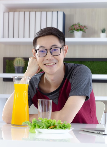 Portrait of smiling man with drink on table