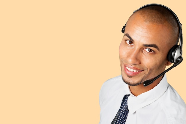 Portrait of a smiling man with headset working as a call center operator