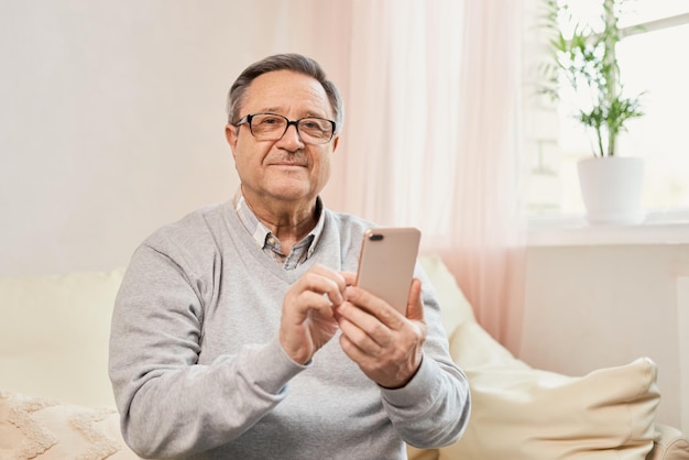 Portrait of smiling mature man using mobile phone