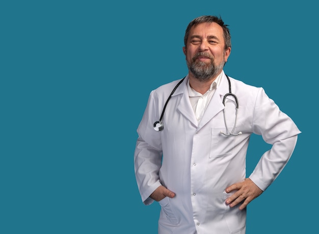 Portrait of a smiling medical doctor with stethoscope posing against white background