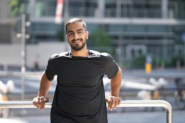 Portrait of smiling middle eastern confident man smiling and looking at camera