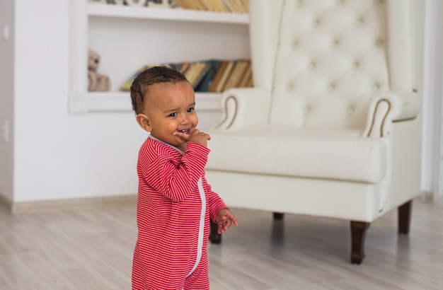 Portrait of smiling mixed race baby at home.