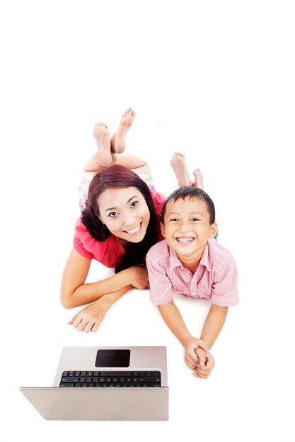 Photo portrait of smiling mother and son with laptop over white background