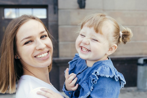 portrait of smiling mother with daughter at home