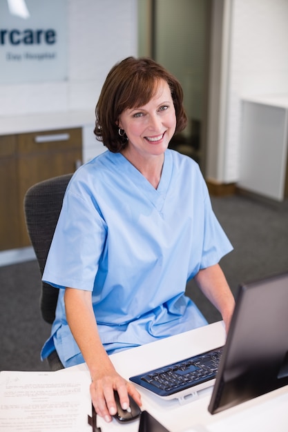 Portrait of smiling nurse working at desk