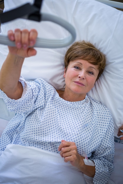 Portrait of smiling patient lying on bed