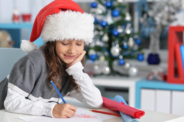 Portrait of smiling preteen girl in Santa hat