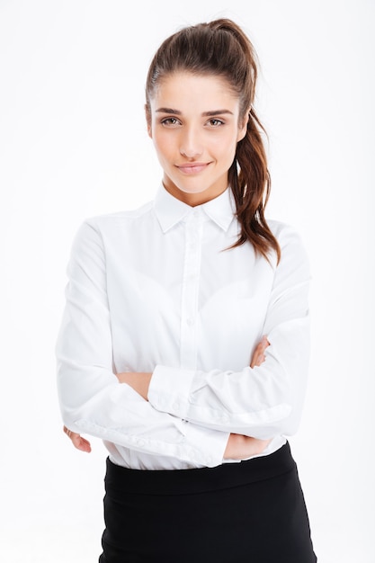 Portrait of smiling pretty young businesswoman standing with arms crossed