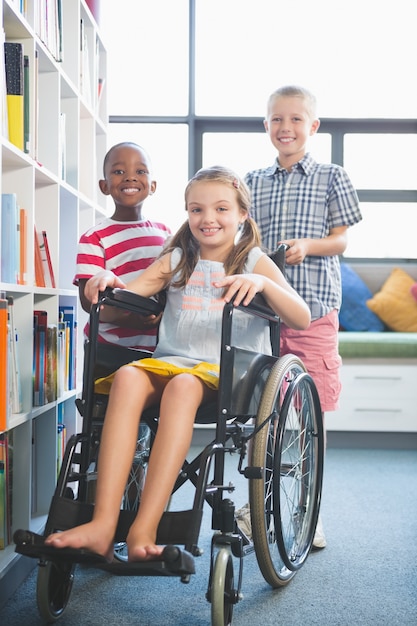 Portrait of smiling school kids in library