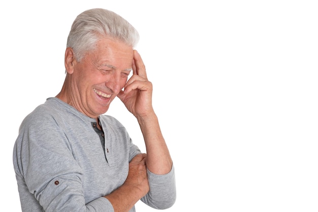 Portrait of smiling senior man on white background