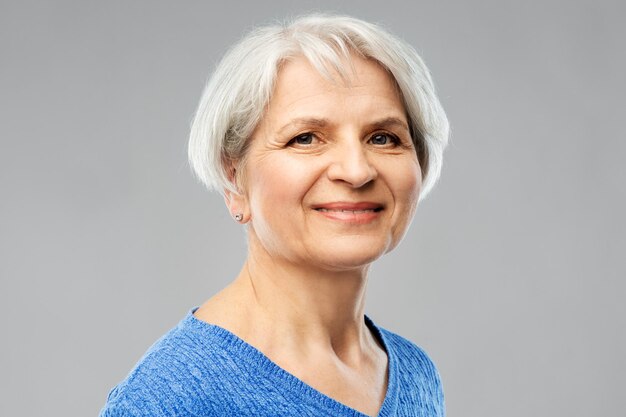 portrait of smiling senior woman in blue sweater