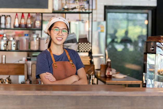 portrait of smiling waitress standing at cafe