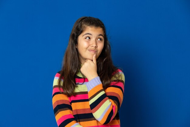 Portrait of smiling woman against blue background