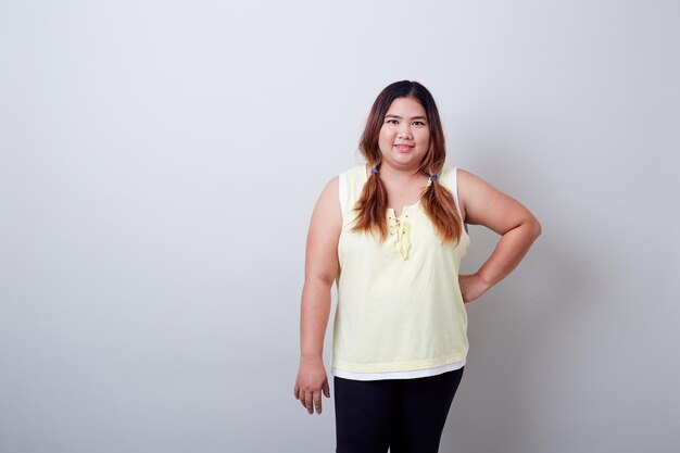 Portrait of smiling woman against gray background