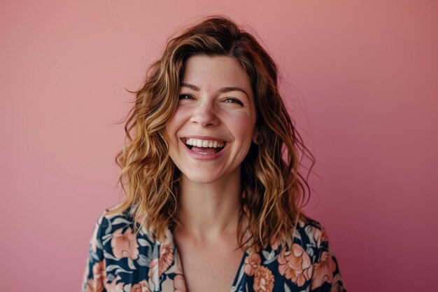 Portrait of a smiling woman against a pink background