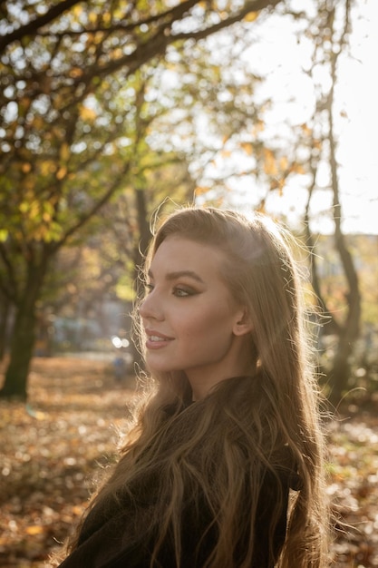 Portrait of smiling woman against trees