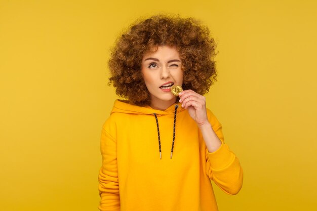 Portrait of a smiling woman against yellow background