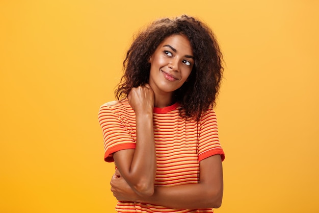 Portrait of smiling woman against yellow background