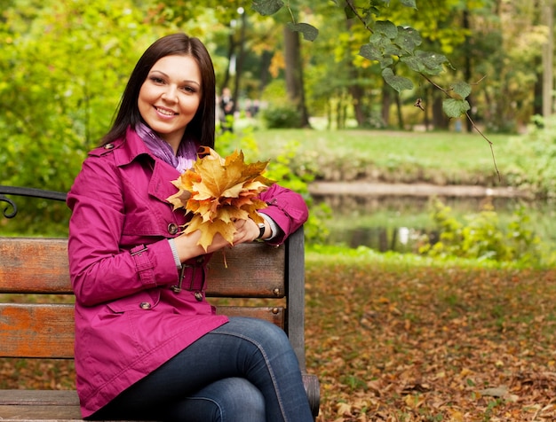 Portrait of smiling woman in autumn park