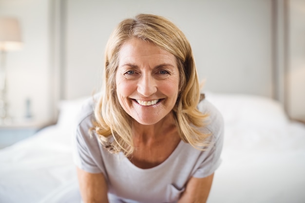 Portrait of smiling woman in bedroom