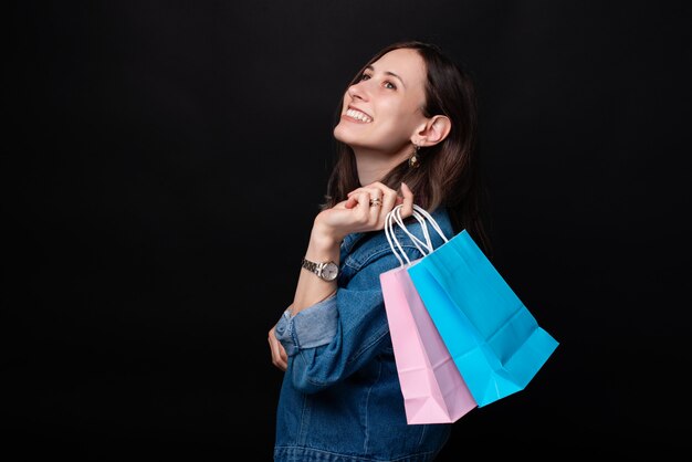 Portrait of smiling woman in casual with colorful shopping bags