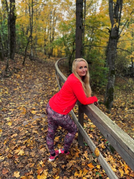 Portrait of smiling woman in forest during autumn