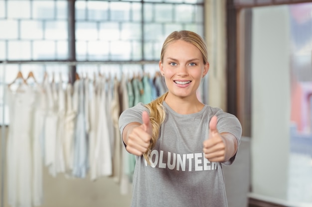 Portrait of smiling woman giving thumbs up 