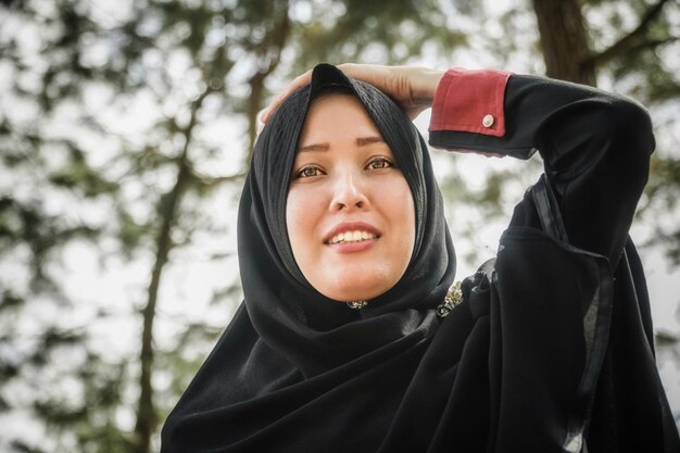 Portrait of smiling woman in headscarf