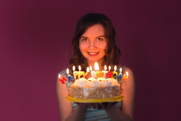 Photo portrait of smiling woman holding illuminated candle